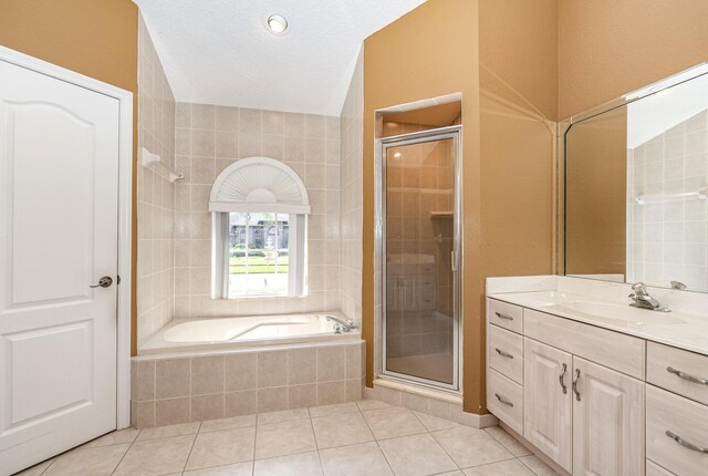 bathroom with tile patterned flooring, vanity, and independent shower and bath