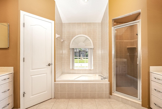 bathroom with tile patterned flooring, vanity, and plus walk in shower