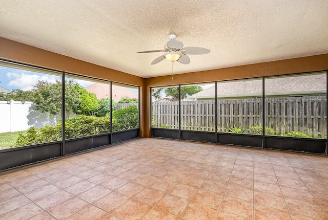 unfurnished sunroom with ceiling fan