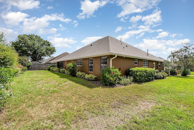 view of side of home with a lawn