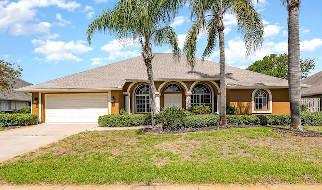 single story home with a front yard and a garage