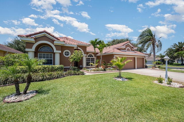 mediterranean / spanish-style home with a garage and a front lawn