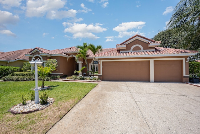 mediterranean / spanish home featuring a front lawn and a garage