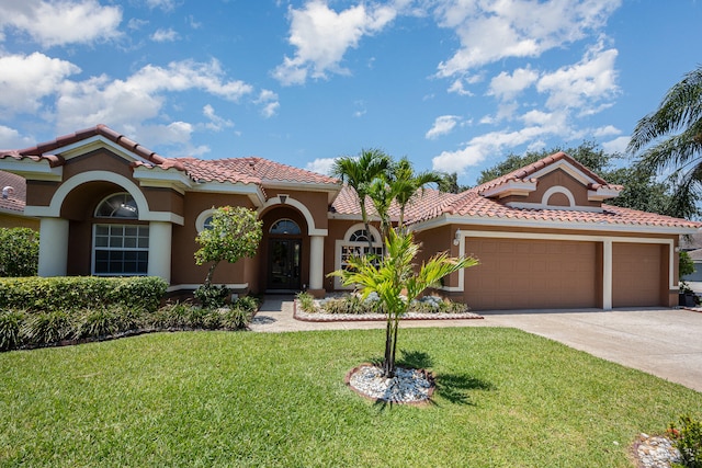 mediterranean / spanish-style house featuring a front lawn and a garage