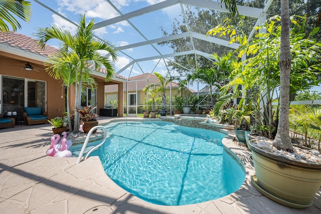 view of swimming pool featuring a patio, ceiling fan, and a lanai