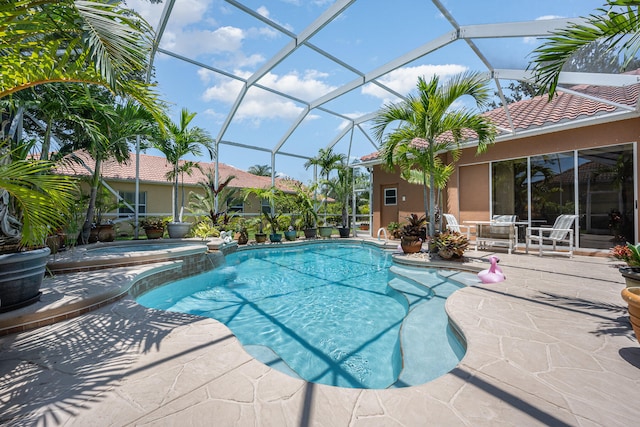 view of pool with a lanai, an in ground hot tub, and a patio