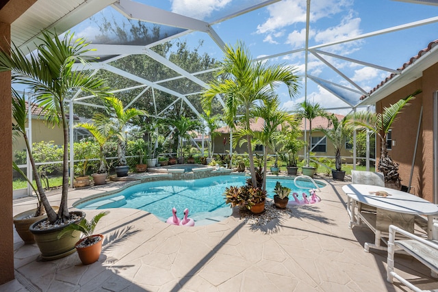 view of pool with glass enclosure, an in ground hot tub, and a patio