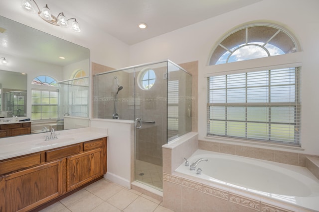 bathroom with tile patterned flooring, vanity, and separate shower and tub