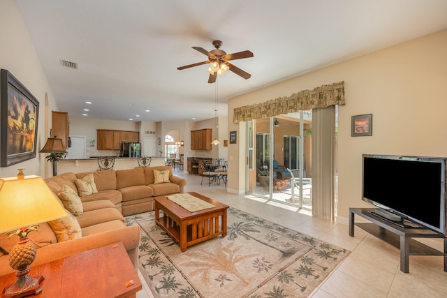 tiled living room with ceiling fan