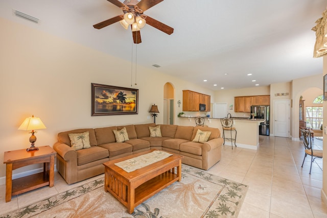 tiled living room with ceiling fan