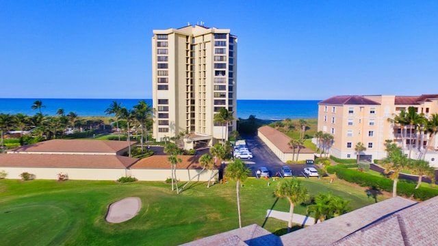 exterior space featuring a lawn and a water view