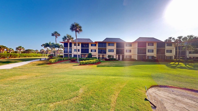 view of property's community with a lawn