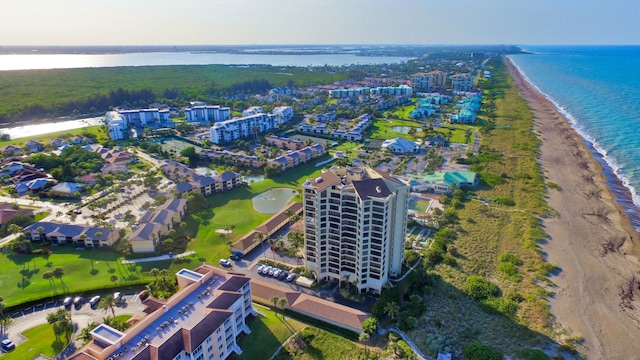 drone / aerial view featuring a view of the beach and a water view