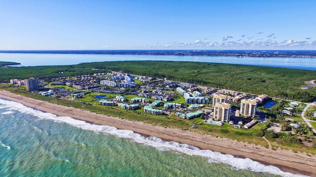 birds eye view of property with a beach view and a water view