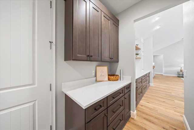 kitchen featuring light wood-type flooring and dark brown cabinetry