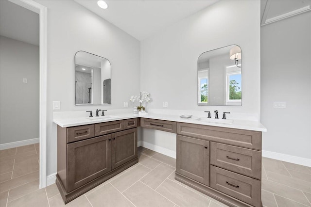 bathroom featuring tile flooring, vanity with extensive cabinet space, and double sink