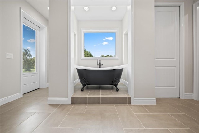 bathroom featuring a healthy amount of sunlight and tile flooring