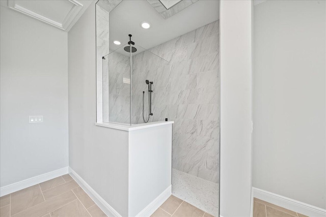 bathroom with tiled shower and tile floors