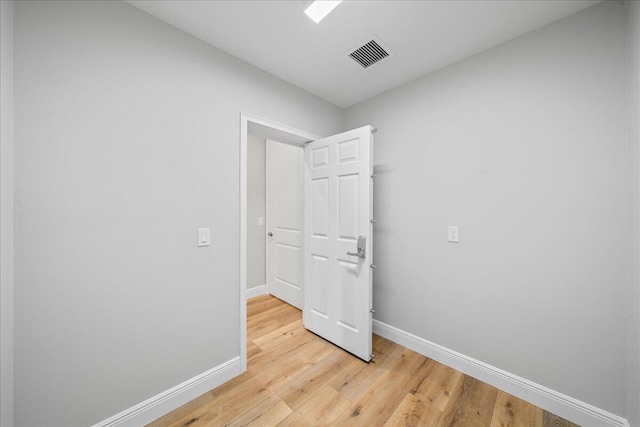 empty room with light hardwood / wood-style floors