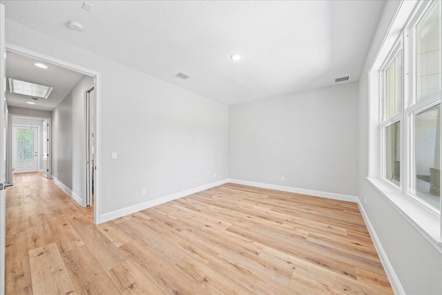 unfurnished room with light wood-type flooring