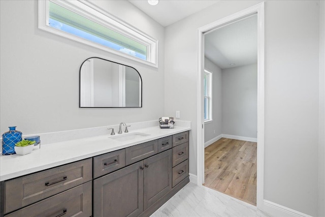 bathroom featuring a healthy amount of sunlight, tile flooring, and vanity