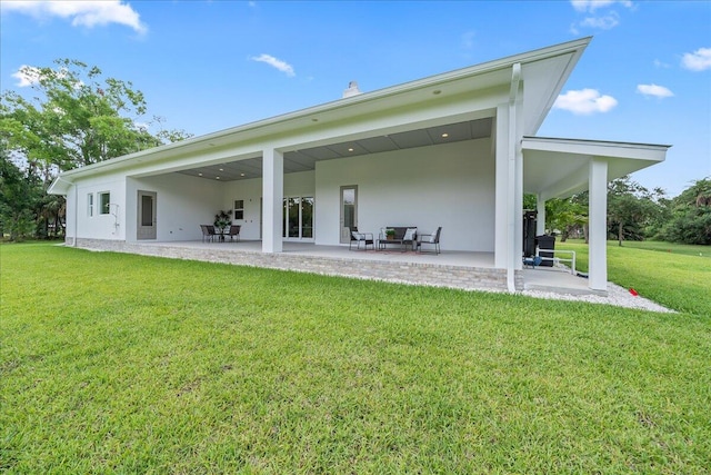 back of house featuring a patio area and a yard