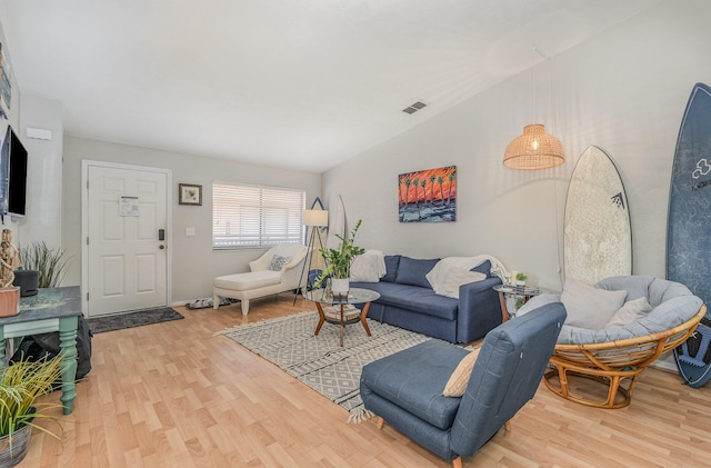 living room with lofted ceiling and wood-type flooring