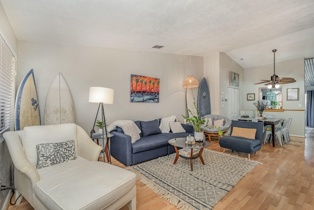 living room featuring ceiling fan, vaulted ceiling, and hardwood / wood-style floors