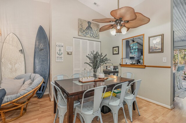 dining space featuring high vaulted ceiling, ceiling fan, and light hardwood / wood-style floors