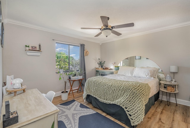 bedroom featuring ceiling fan, ornamental molding, and hardwood / wood-style flooring