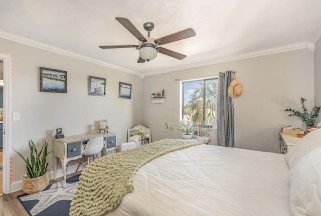 bedroom with ceiling fan, hardwood / wood-style floors, and ornamental molding