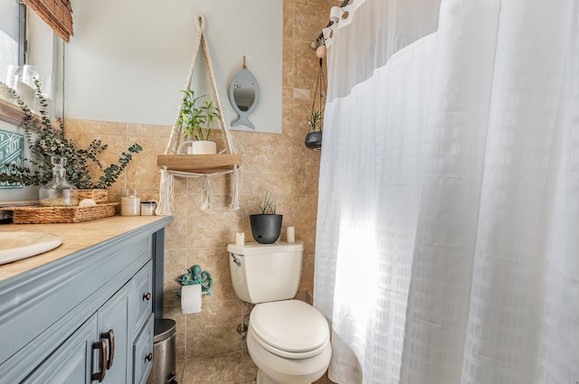 bathroom with tile walls, toilet, tile floors, and vanity