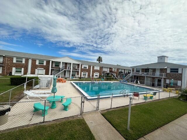 view of pool featuring a lawn and a patio area