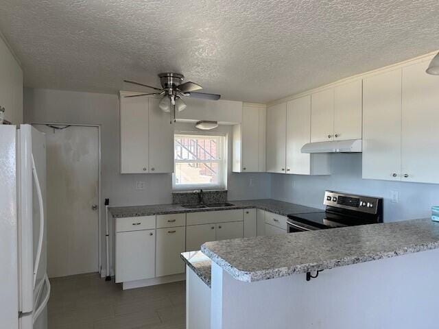 kitchen featuring white cabinets, white refrigerator, stainless steel electric range oven, and kitchen peninsula