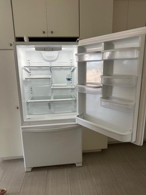 details with refrigerator, light hardwood / wood-style floors, and white cabinetry