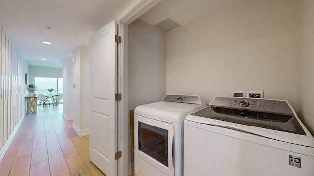 washroom with hookup for a washing machine, washer and clothes dryer, and light wood-type flooring