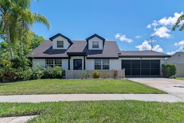 view of front of home with a garage and a front lawn