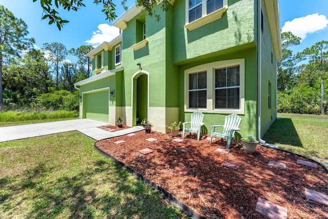 view of front of property featuring a front yard and a garage