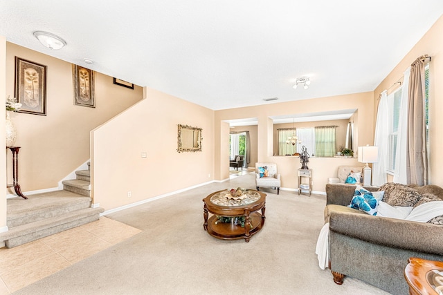 carpeted living room with a textured ceiling and an inviting chandelier