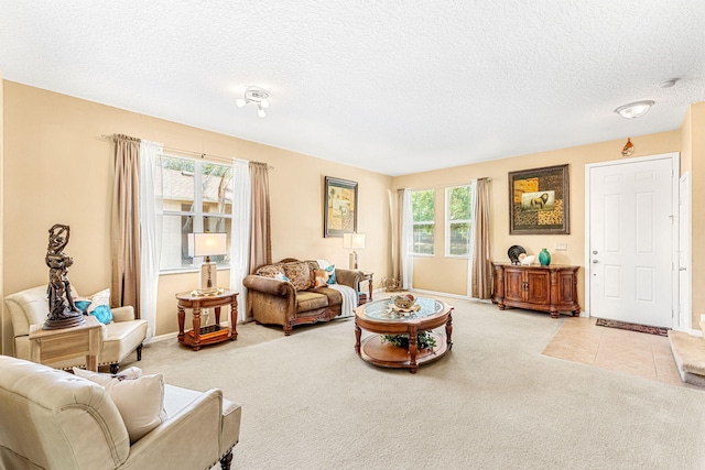 living room featuring light carpet, a healthy amount of sunlight, and a textured ceiling