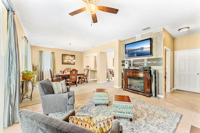 living room with a textured ceiling and ceiling fan