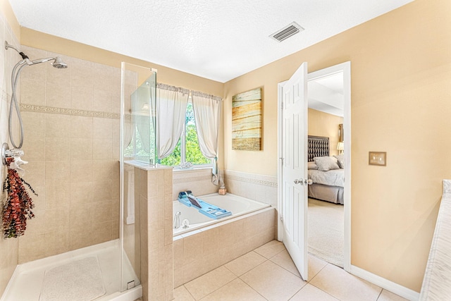 bathroom featuring tile patterned flooring, a textured ceiling, and plus walk in shower