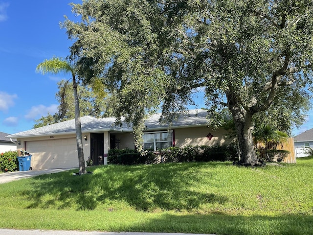 ranch-style house with a garage and a front lawn