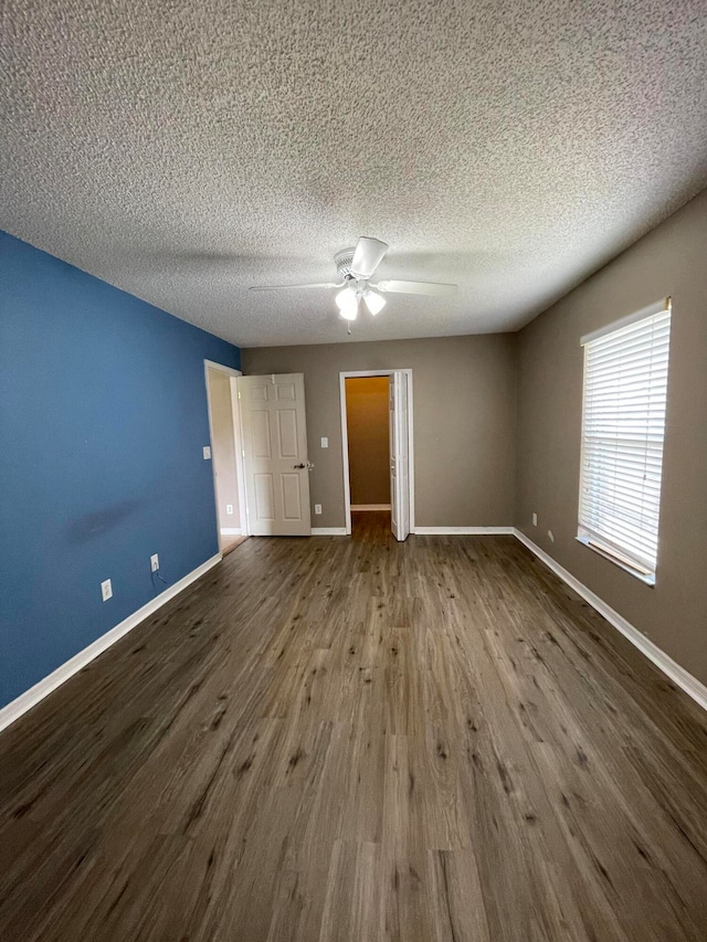 unfurnished bedroom featuring a textured ceiling, ceiling fan, and wood-type flooring