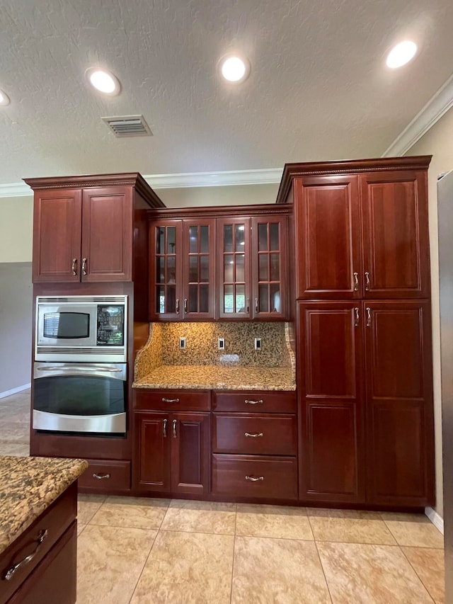 kitchen featuring backsplash, light tile patterned flooring, light stone countertops, stainless steel appliances, and ornamental molding