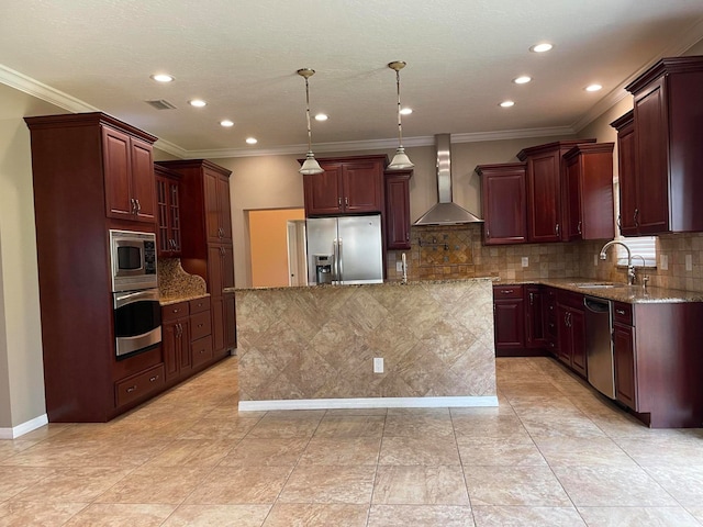 kitchen with stainless steel appliances, a center island, hanging light fixtures, wall chimney exhaust hood, and sink