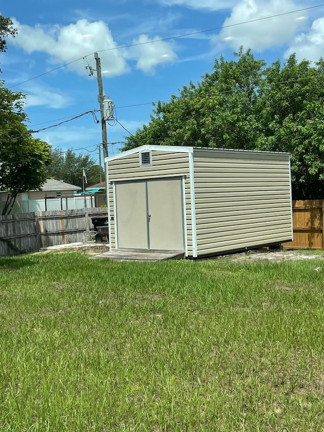 view of outdoor structure featuring a lawn