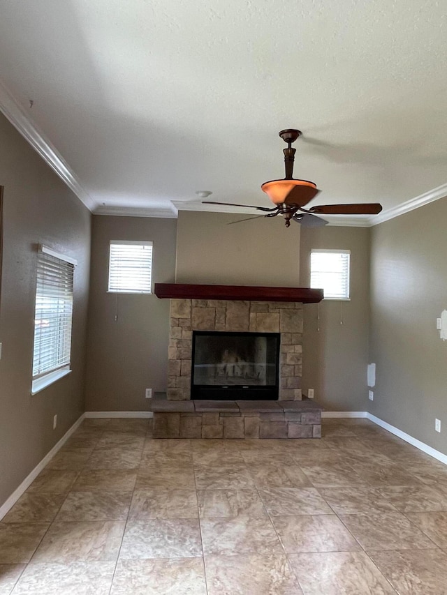 unfurnished living room with ceiling fan, ornamental molding, and a fireplace