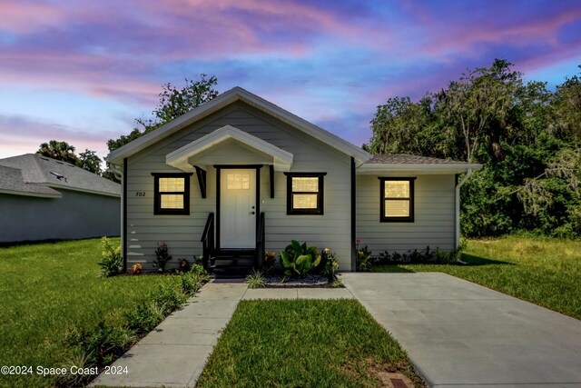 702 S Myrtle Ave, New Smyrna Beach, FL 32168 - bungalow-style house with a yard