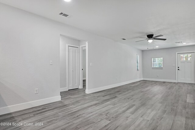 702 S Myrtle Ave, New Smyrna Beach, FL 32168 - unfurnished living room featuring baseboards, ceiling fan, visible vents, and wood finished floors
